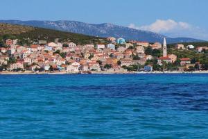 a town on the shore of a body of water at Stonehouse on peaceful Island of Unije in Unije