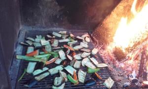 a bunch of vegetables cooking on a grill at Kulla e Vjeter (Bar Restaurant, Guesthouse, Parking and Camping) in Koman