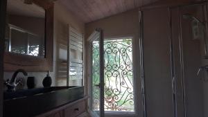 a kitchen with a glass door with a window at La petite Boulandre in Saint-Antoine-de-Breuilh