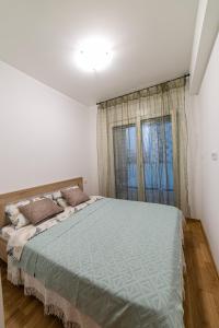 Postel nebo postele na pokoji v ubytování Apartman Miss T
