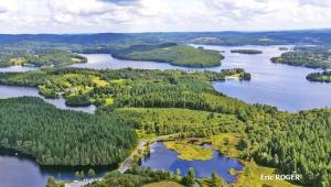 an aerial view of a group of lakes and forests at Appartement rouge avec jardin in Eymoutiers