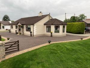 une maison avec une pelouse devant elle dans l'établissement Steeple View B&B Guesthouse Donegal - Newly renovated in 2023, à Ballybofey