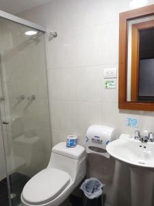 a bathroom with a toilet and a sink at Embassy On Holidays in Bogotá