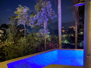 a house with a swimming pool at night at BELA VISTA RESERVAs in Petrópolis