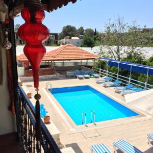 a view of a swimming pool from a balcony at Akay Hotel in Patara