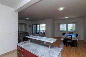 a kitchen and living room with a table and chairs at Apartments Janja in Trogir