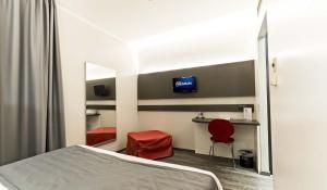 Televízia a/alebo spoločenská miestnosť v ubytovaní Ilga Hotel
