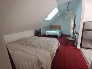 a small bedroom with two beds and a window at Va Beach Zen tree house style studio F in Virginia Beach