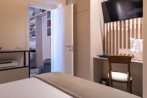 a bedroom with a bed and a desk with a chair at Zisa Suite in Palermo