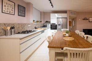 a kitchen with a wooden table and a counter top at Eilat vacation house דירות נופש אילת in Eilat