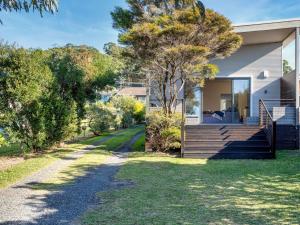 a home with a pathway leading up to a house at Neptune Hyams Beach in Hyams Beach