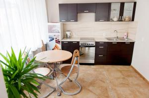 a small kitchen with a table and a sink at Dom Wczasowy Natalia in Łeba