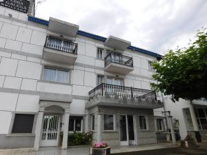 a white building with two balconies on it at HOTEL TERRA GALEGA MEIGA in Monforte de Lemos