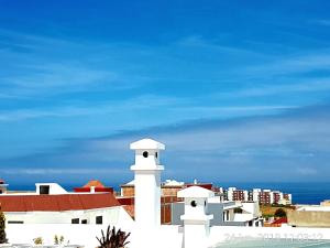 ein weißes Gebäude mit dem Ozean im Hintergrund in der Unterkunft luxe appartement Nour D'asilah 3 in Asilah