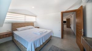a bedroom with a large bed with a window at Midpoint Suites in Fethiye