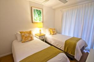 A bed or beds in a room at Noosa Keys Resort