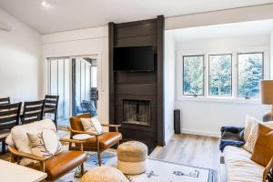 a living room with a fireplace and a tv at Fish Creek Point in Wilson