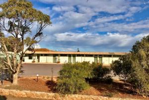 an empty building with trees in front of it at Highway One Motel in Ceduna