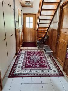 a hallway with a rug on the floor and stairs at Paljakka Mökit in Kotila