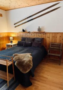 a bedroom with a large bed in a room with wooden walls at Paljakka Mökit in Kotila