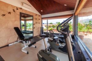 una palestra con 2 tapis roulant e uno specchio di La Palm by StayVista - Mountain-view villa, boasting a spacious pool, Gym, Indoor games, Basketball court & A lush lawn with a gazebo a Lonavala