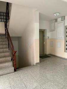 an empty room with stairs and a stair case at The View Apartment in Constanţa