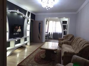 a living room with a couch and a table at Apartment for you in Tbilisi City