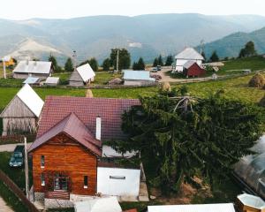 an aerial view of a farm with mountains in the background at Pensiunea Maris, Maguri, Maguri-Racatau in Bogdăneşti