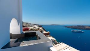 a view from the side of a building looking down at the water at Katris Apartments in Fira