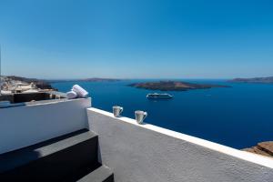 a view of the ocean from a balcony of a house at Katris Apartments in Fira