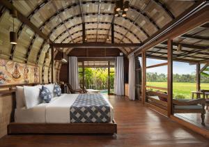 a bedroom with a large bed in a room at Beehouse Dijiwa Ubud in Ubud +70 photos
