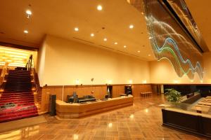 a large lobby with a staircase and a stage at Hotel Tokyo Garden Palace in Tokyo