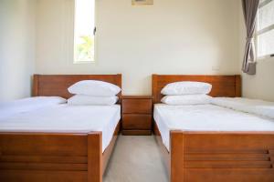 Postel nebo postele na pokoji v ubytování Tian Mama Homestay