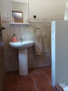 a bathroom with a sink and a mirror at Casa Mirlo in Montmesa