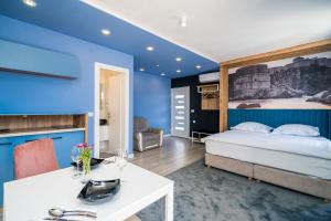 a bedroom with a bed and a blue wall at Apartments Tayra in Dubrovnik
