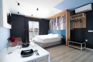 a hotel room with a bed and a white table at Apartments Tayra in Dubrovnik