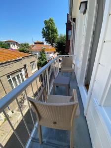 a balcony with two chairs and a table at White Island Boutique Otel in Adalar