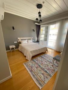 a bedroom with a large bed and a rug at White Island Boutique Otel in Adalar