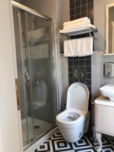 a bathroom with a toilet and a shower at White Island Boutique Otel in Adalar +22 photos
