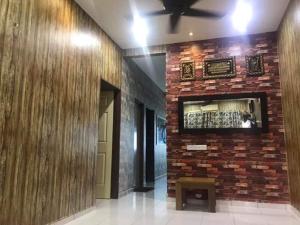 a brick wall in a hallway with a bench on it at No 96 Nazirin Homestay Lumut in Lumut