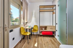 a room with two yellow chairs and a desk at City Experience Apartments A in Heraklio