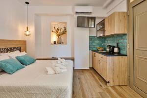 a bedroom with a large bed and a kitchen at City Experience Apartments A in Heraklio Town