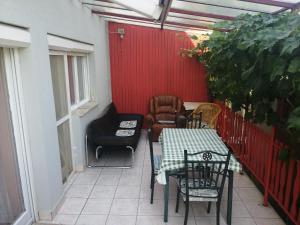 a patio with chairs and a table and a table and chairs at Pálinkás jó reggelt! in Hévíz +25 photos