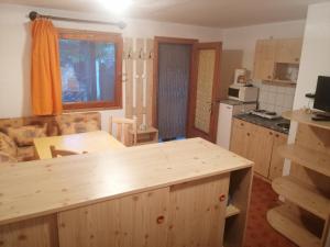 a kitchen and living room with a wooden counter top at Pálinkás jó reggelt! in Hévíz