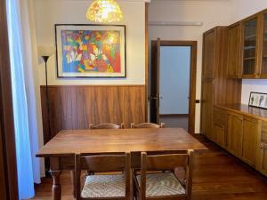 a dining room with a wooden table and chairs at Verona in musica apartment in Verona +5 photos