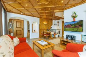 a living room with a couch and a table at Steinberger Hof in Ruhpolding