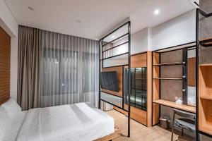a bedroom with a bed and a desk at LOA Living Solo Baru in Sukoharjo