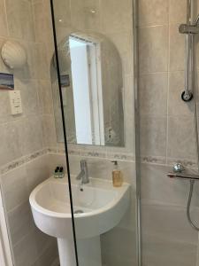 a bathroom with a sink and a shower at Marina Metro Hotel in Saint Helier Jersey