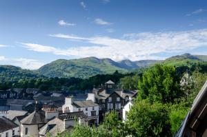 a town in the mountains with houses and trees at Fell View Retreat in Ambleside