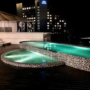 a swimming pool on top of a building at night at Pine Forest Jeongseon Alpine Resort in Jeongseon